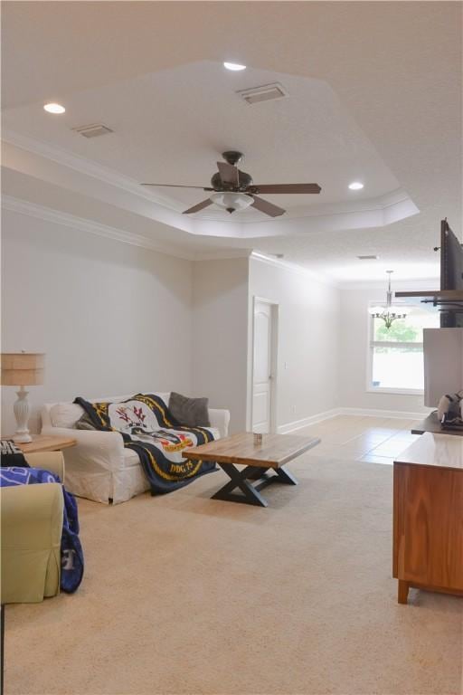 interior space with visible vents, crown molding, light carpet, a tray ceiling, and recessed lighting