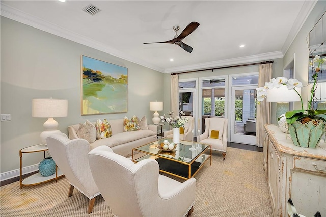 living room with a ceiling fan, visible vents, ornamental molding, and baseboards