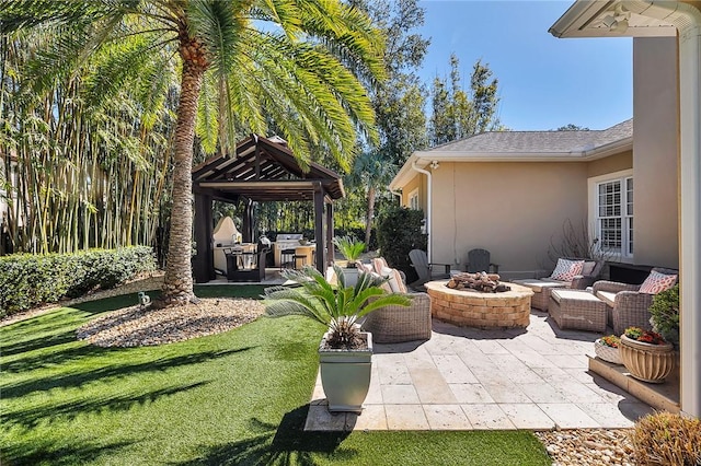 view of patio featuring an outdoor fire pit and a gazebo