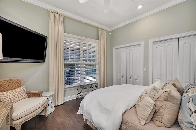 bedroom featuring recessed lighting, baseboards, multiple closets, dark wood-style floors, and crown molding