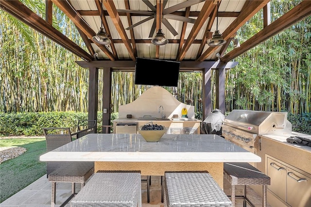 view of patio featuring a gazebo, a grill, ceiling fan, a sink, and exterior kitchen