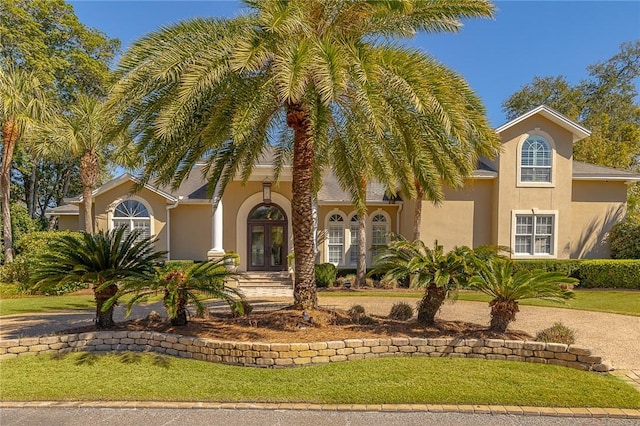 mediterranean / spanish house with french doors and stucco siding