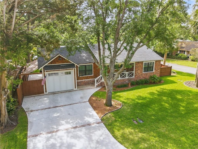 view of front of house featuring brick siding, a shingled roof, driveway, a front yard, and an attached garage