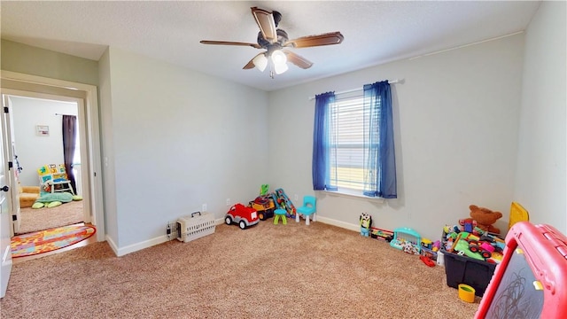 playroom featuring baseboards, ceiling fan, and carpet flooring