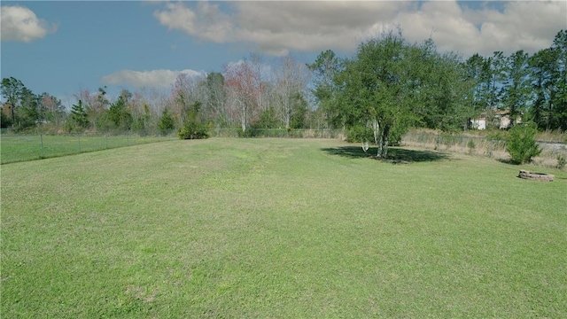 view of yard featuring a rural view and a fenced backyard