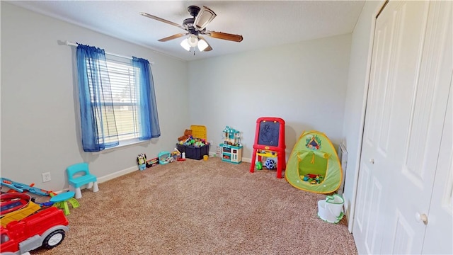 rec room with baseboards, carpet, and ceiling fan