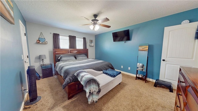 bedroom featuring baseboards, carpet floors, a textured ceiling, and ceiling fan