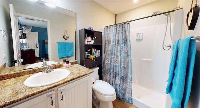 bathroom with tile patterned flooring, toilet, vanity, and a shower with curtain