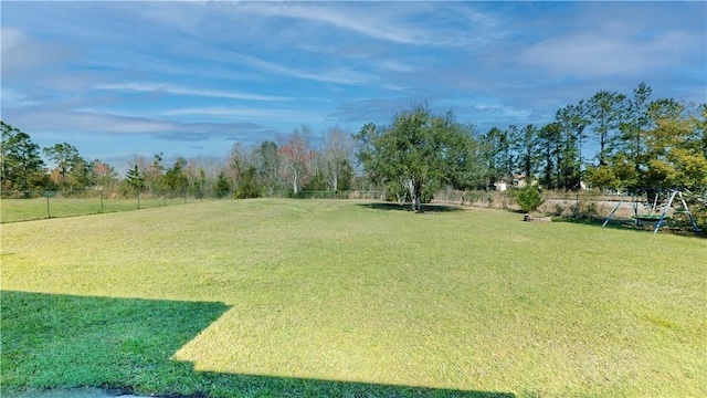 view of yard with playground community and a fenced backyard