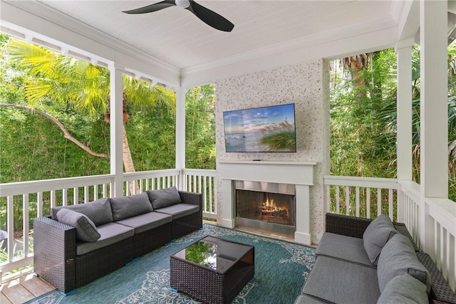 1153 Ocean Blvd, Saint Simons Island, GA 31522 - sunroom featuring ceiling fan, an outdoor living space with a fireplace, and plenty of natural light