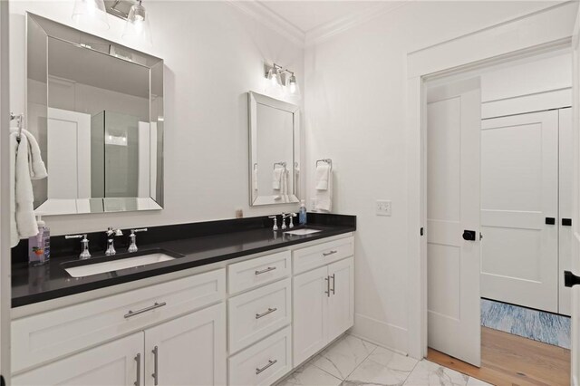1153 Ocean Blvd, Saint Simons Island, GA 31522 - full bathroom with double vanity, ornamental molding, marble finish flooring, and a shower with shower door