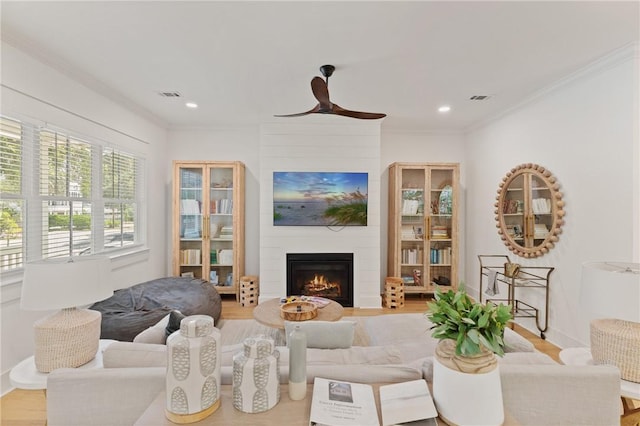 1153 Ocean Blvd, Saint Simons Island, GA 31522 - living room with wood finished floors, a large fireplace, recessed lighting, and ornamental molding
