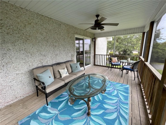 unfurnished sunroom featuring ceiling fan