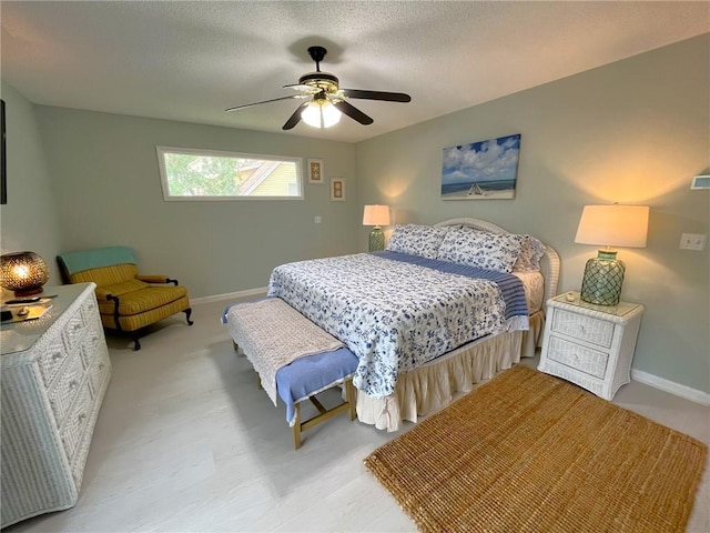 carpeted bedroom with ceiling fan and a textured ceiling