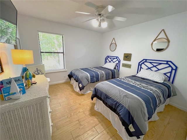 bedroom featuring light wood-type flooring and ceiling fan