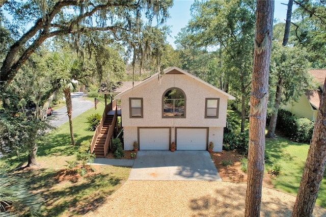 view of front of house with a garage and a front lawn