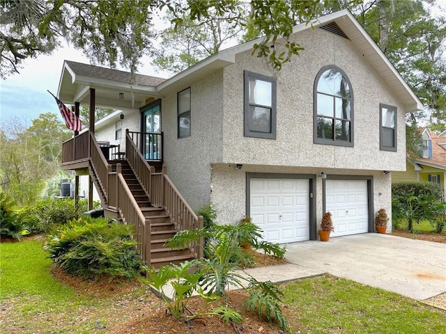 view of front of home with a garage and central air condition unit