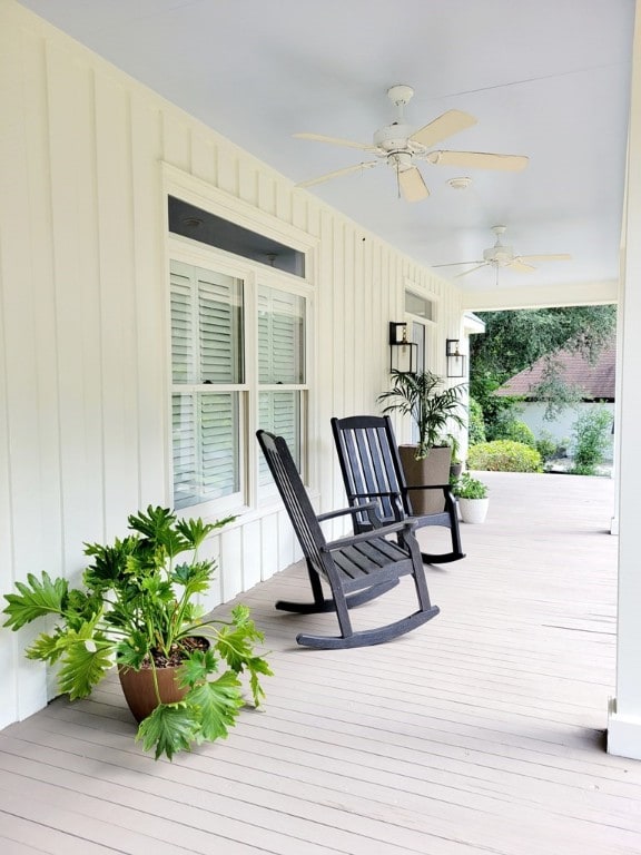 wooden terrace with ceiling fan and a porch