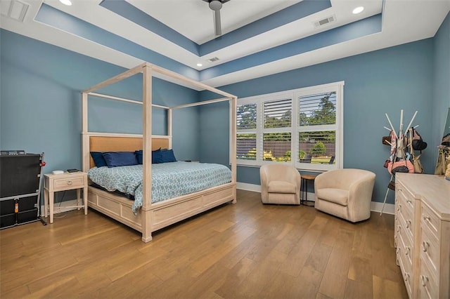 147 Butler Lake Dr, Saint Simons Island, GA 31522 - bedroom featuring a tray ceiling, wood finished floors, and recessed lighting