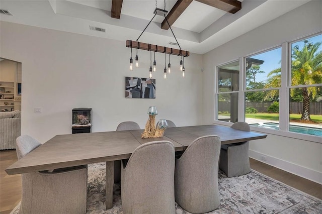 147 Butler Lake Dr, Saint Simons Island, GA 31522 - dining area featuring healthy amount of natural light, wood finished floors, and beam ceiling