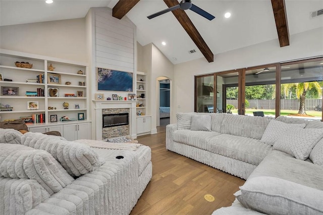 147 Butler Lake Dr, Saint Simons Island, GA 31522 - living area with ceiling fan, beamed ceiling, light wood finished floors, recessed lighting, and a glass covered fireplace