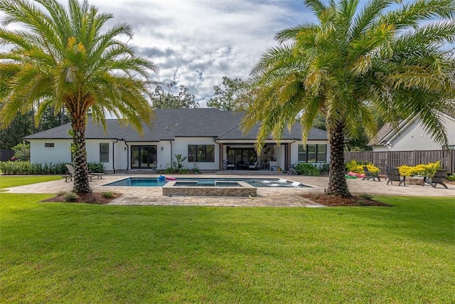 147 Butler Lake Dr, Saint Simons Island, GA 31522 - back of property featuring a patio, a pool with connected hot tub, and stucco siding