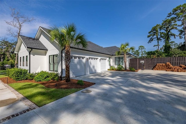 147 Butler Lake Dr, Saint Simons Island, GA 31522 - single story home with a garage, driveway, and stucco siding