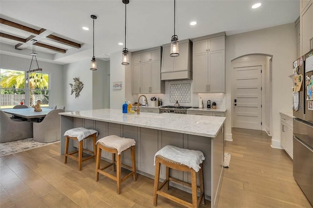 147 Butler Lake Dr, Saint Simons Island, GA 31522 - kitchen featuring recessed lighting, decorative backsplash, gray cabinetry, beam ceiling, and a breakfast bar