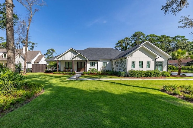 147 Butler Lake Dr, Saint Simons Island, GA 31522 - view of front facade featuring a front lawn and board and batten siding