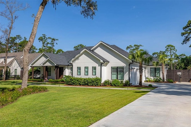 147 Butler Lake Dr, Saint Simons Island, GA 31522 - view of front of house featuring concrete driveway, a garage, and stucco siding