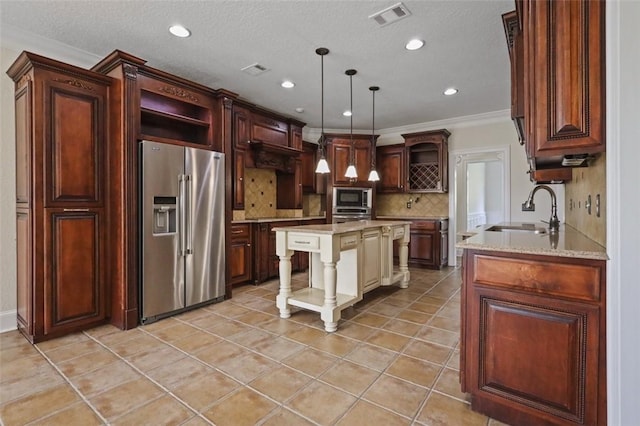 kitchen featuring appliances with stainless steel finishes, backsplash, sink, pendant lighting, and a center island