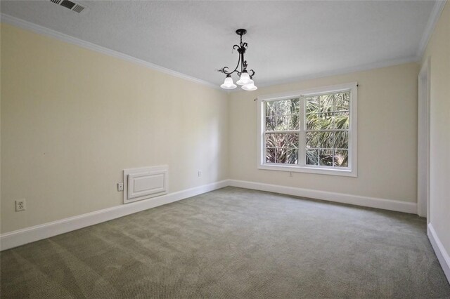 carpeted spare room featuring crown molding and a notable chandelier