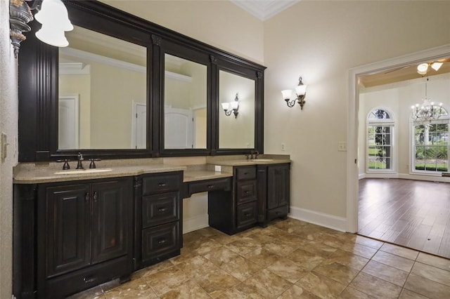 bathroom with a chandelier, hardwood / wood-style floors, vanity, and ornamental molding