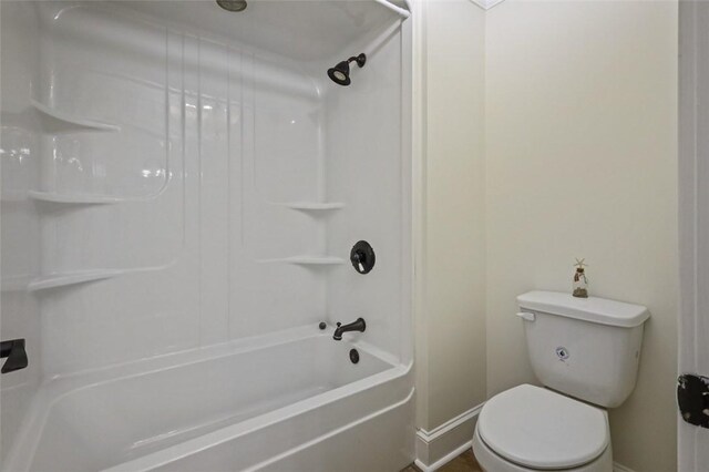 bathroom with shower / bathtub combination and toilet