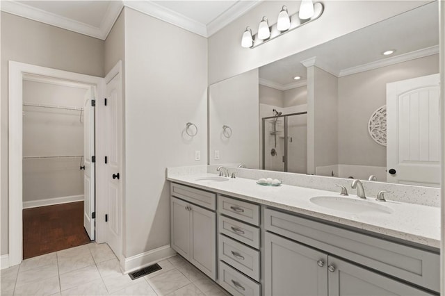 full bathroom featuring a stall shower, a sink, and crown molding