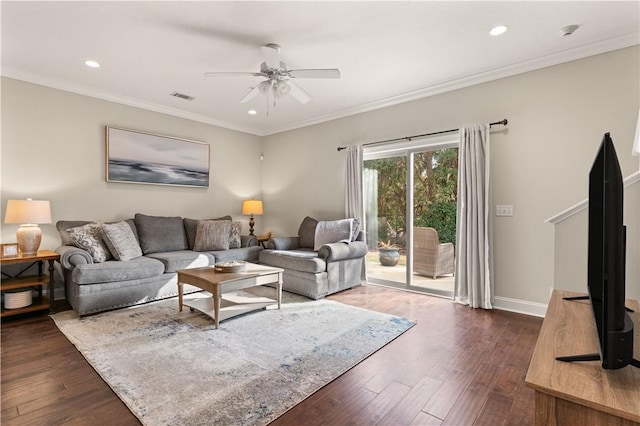 living room with baseboards, visible vents, dark wood finished floors, and ornamental molding