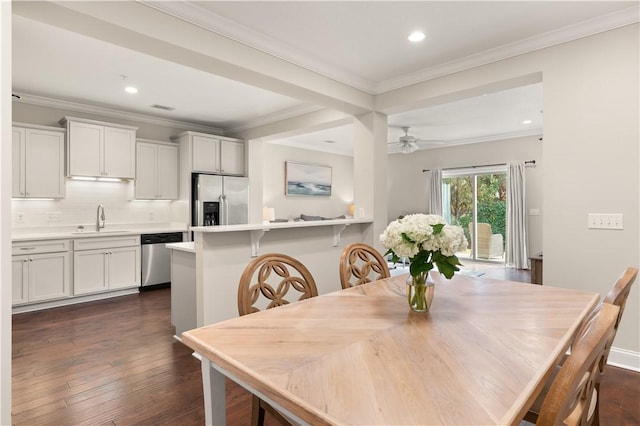 dining area with ceiling fan, recessed lighting, dark wood finished floors, and crown molding