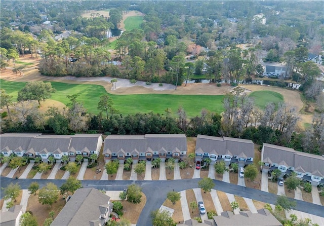 drone / aerial view featuring view of golf course and a residential view