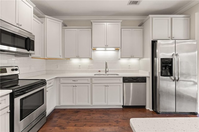 kitchen featuring a sink, stainless steel appliances, light countertops, and white cabinets