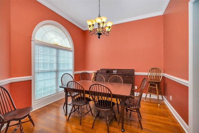 253 Winding Trl, Brunswick, GA 31523 - dining room with healthy amount of natural light, crown molding, a chandelier, and wood finished floors