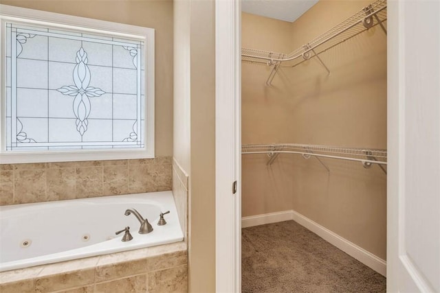 253 Winding Trl, Brunswick, GA 31523 - bathroom with a tub with jets and a walk in closet