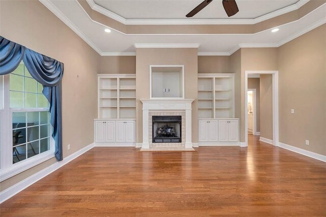 253 Winding Trl, Brunswick, GA 31523 - unfurnished living room featuring wood finished floors, a ceiling fan, a fireplace with flush hearth, recessed lighting, and crown molding