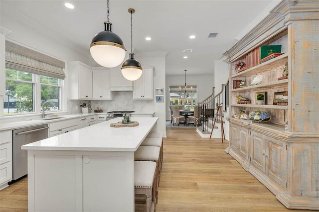 121 Fifty Oaks Ln, Saint Simons Island, GA 31522 - kitchen with stainless steel dishwasher, light countertops, white cabinetry, recessed lighting, and stove