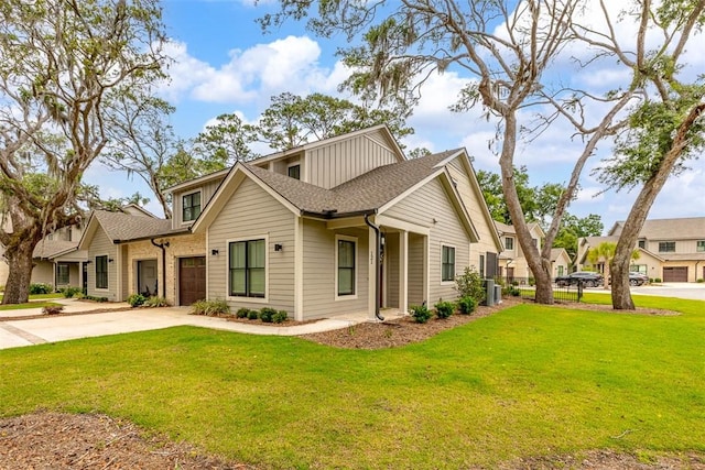 121 Fifty Oaks Ln, Saint Simons Island, GA 31522 - view of front facade with concrete driveway, a front lawn, roof with shingles, and central AC