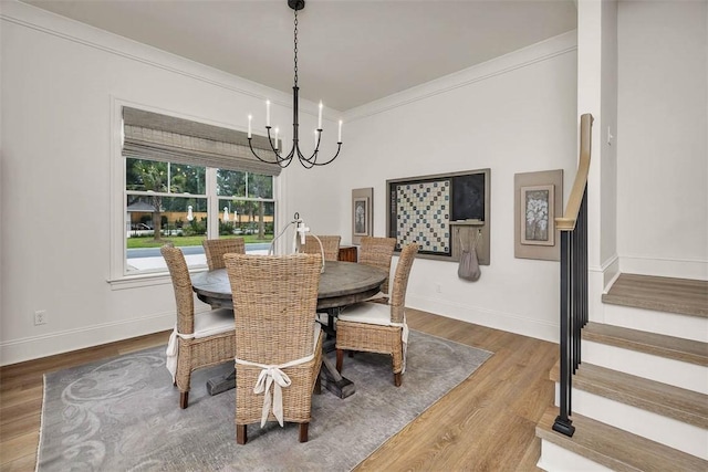 121 Fifty Oaks Ln, Saint Simons Island, GA 31522 - dining space featuring a chandelier, stairway, wood finished floors, baseboards, and ornamental molding