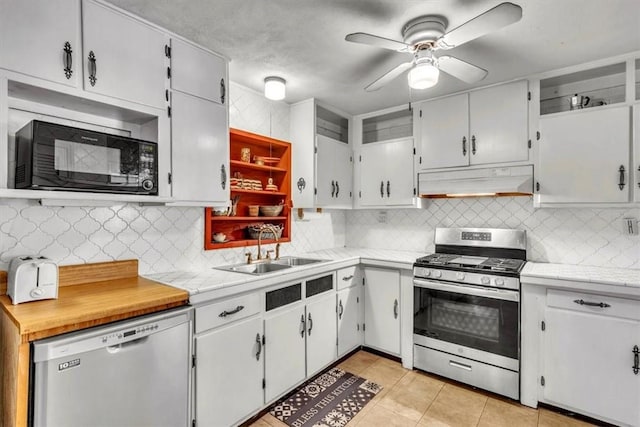 kitchen featuring decorative backsplash, white cabinetry, sink, and appliances with stainless steel finishes