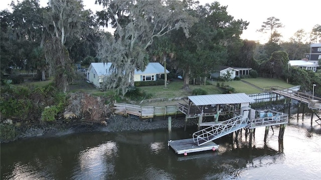 view of dock featuring a yard and a water view