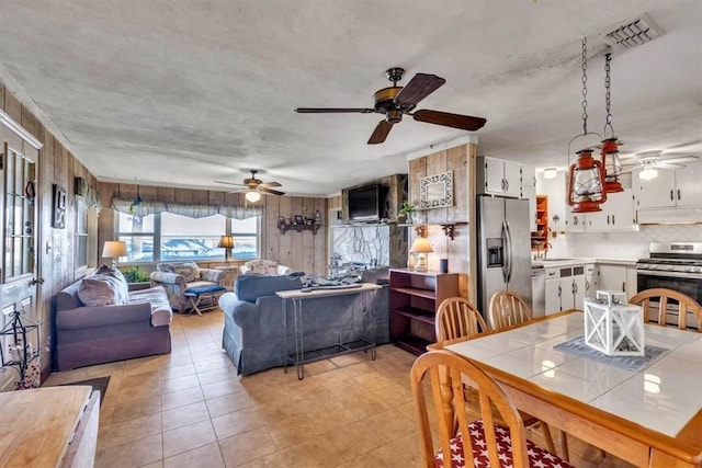 tiled dining room with a textured ceiling