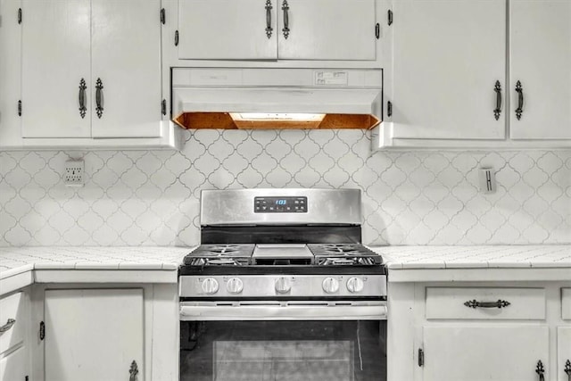 kitchen featuring white cabinets, tasteful backsplash, and stainless steel gas range