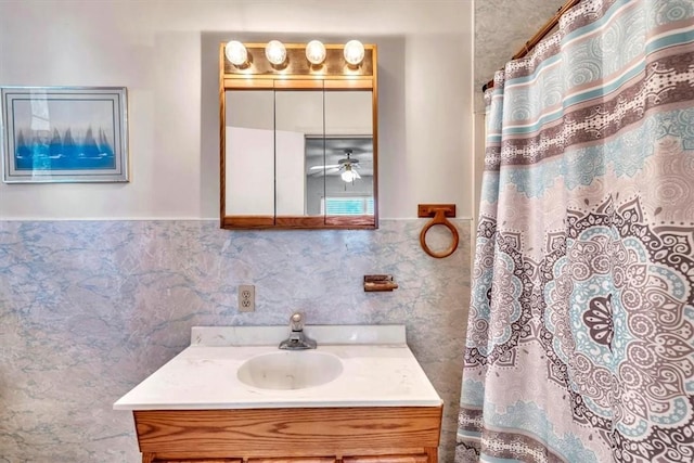 bathroom with vanity and tile walls